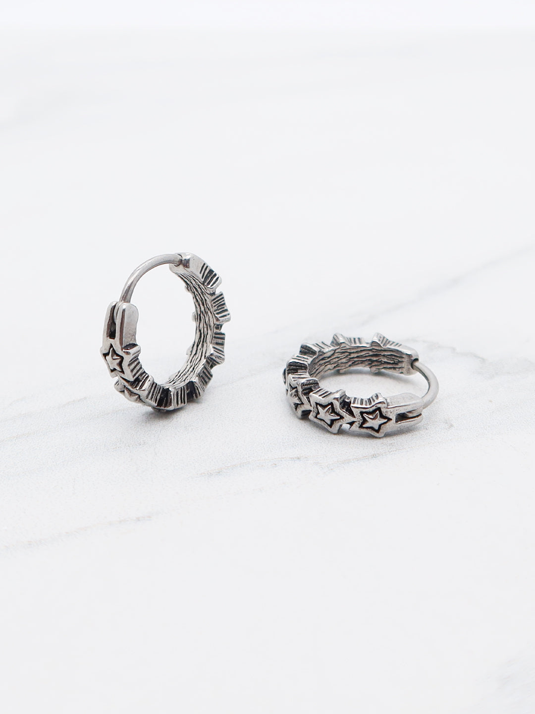Celestial hoop earring with engraved star details, made of high-quality titanium.