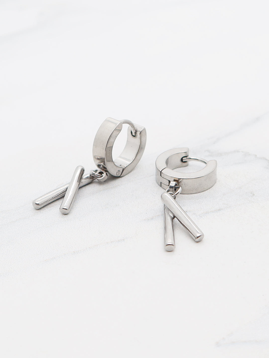 Titanium cross-stick huggie earrings, minimalist unisex design.