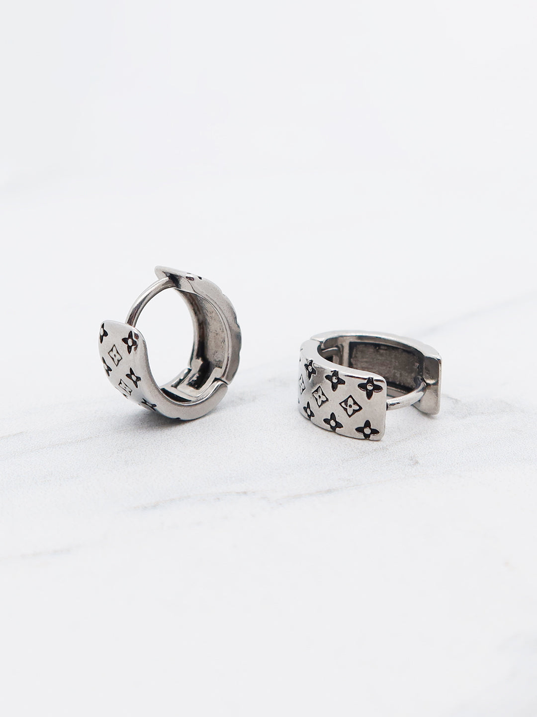 Gothic-inspired titanium hoop earring with engraved details