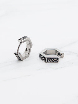Hexagonal hoop earring in stainless steel with engraved patterns.