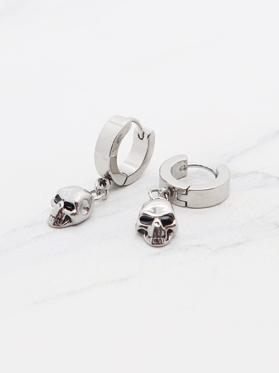 Titanium skull huggie earrings with dangle charm, gothic punk style.