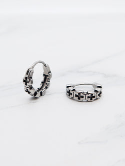 Close-up of titanium Cross Gothic Hoop Earrings with a chain link cross pattern.