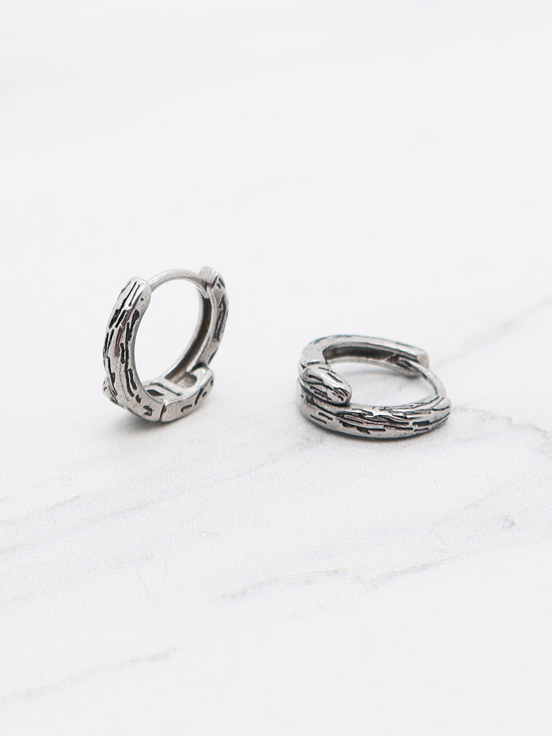 Titanium gothic cross engraved hoop earrings with a secure hinged clasp
