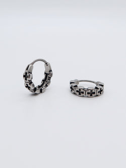 Close-up of titanium Cross Gothic Hoop Earrings with a chain link cross pattern.