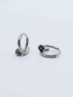 Floral charm hoop earring in stainless steel with delicate details.