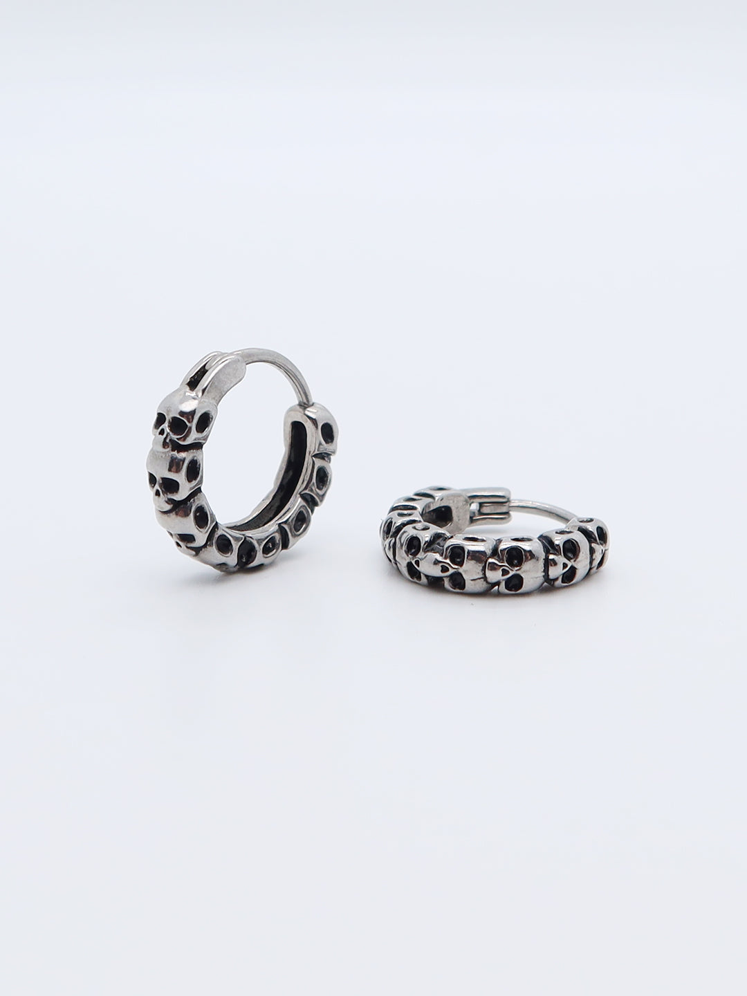 Skull Hoop Earrings in 316L titanium with gothic design on white background.